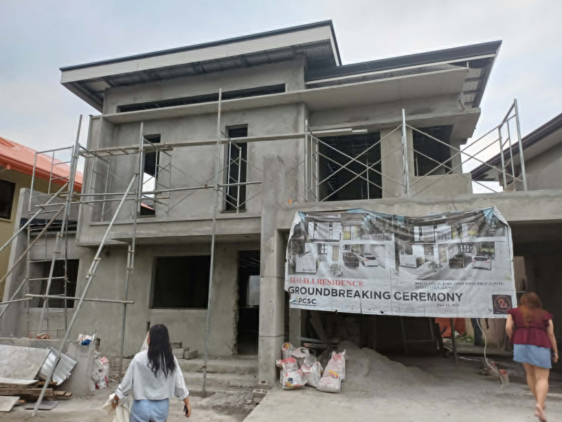 Two-storey structure under construction with scaffolding