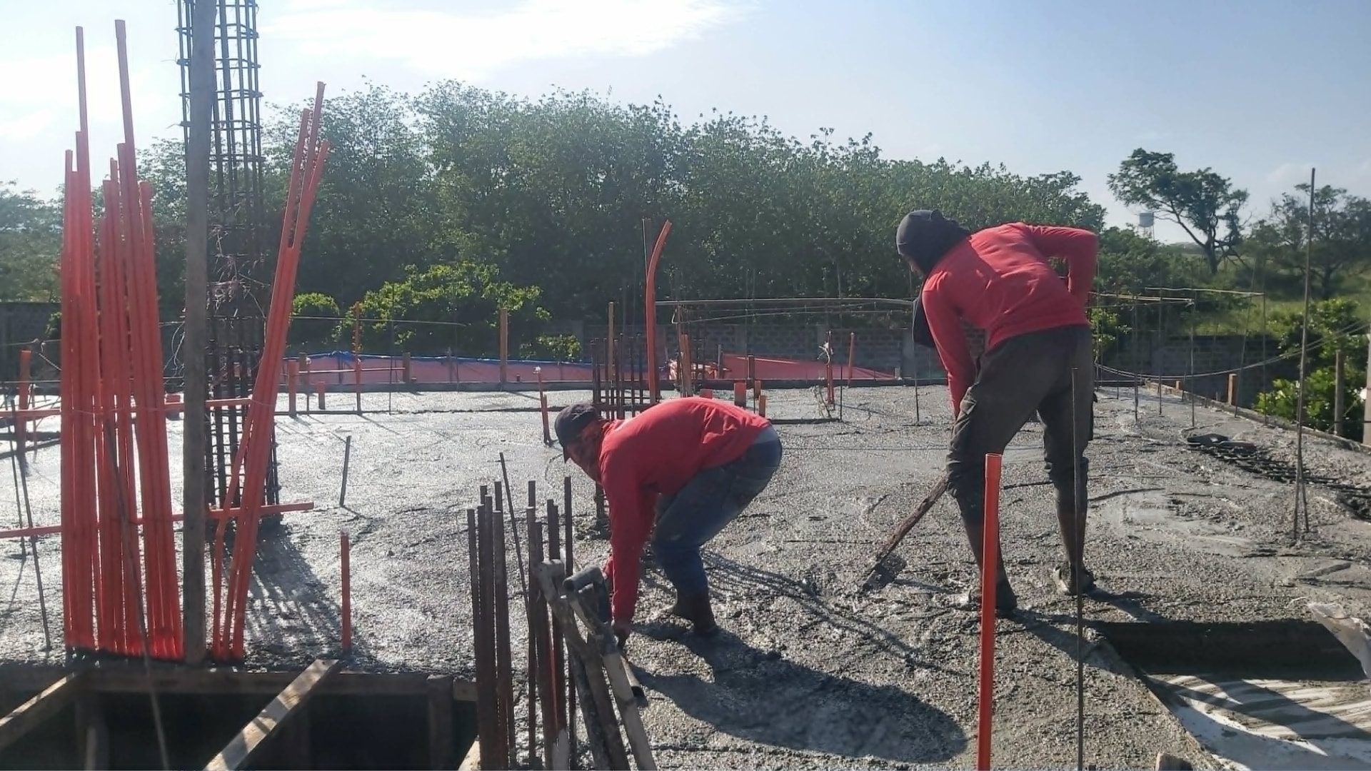 Workers finishing a concrete slab on site